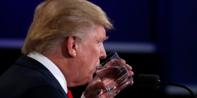Republican U.S. presidential nominee Donald Trump sips water during the third and final debate with Democratic nominee Hillary Clinton (not pictured) at UNLV in Las Vegas, Nevada, U.S., October 19, 2016. REUTERS/Carlos Barria