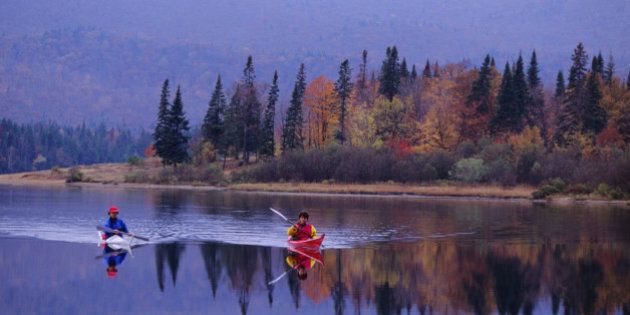 QUEBEC, CANADA - 1992/10/15: People kayaking in the fall on Lake Lac-Monroe, Mont-Tremblant National Park, in the Laurentians in Quebec Province, Canada. (Photo by Wolfgang Kaehler/LightRocket via Getty Images)