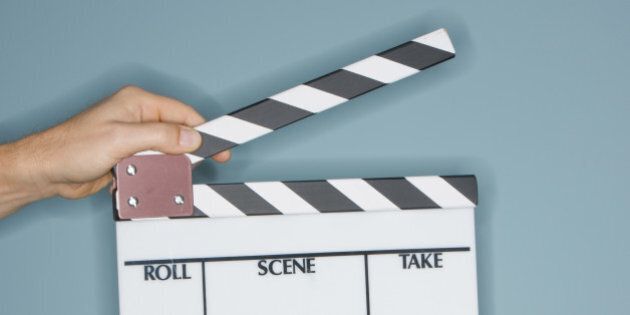 Person holding clapperboard, close-up of hands