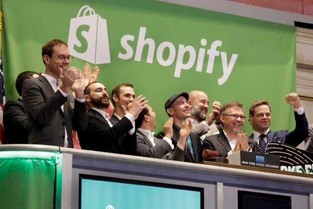 Shopify CEO Tobias Lutke, center wearing hat, is celebrated as he rings the New York Stock Exchange opening bell, marking the Canadian company's IPO, Thursday, May 21, 2015.