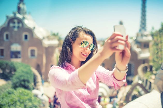Attractive woman taking selfie with smart phone, mobile phone. Modern concept of photography, selfie, beautiful woman taking pictures of herself