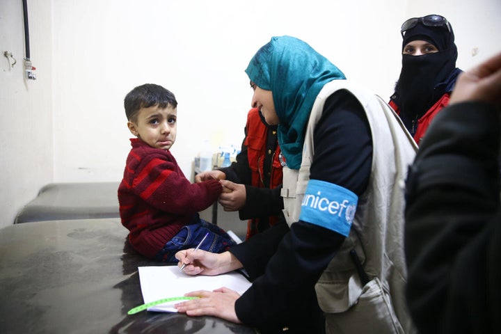 Le 15 mars 2018, une spécialiste de la nutrition de l'UNICEF vérifie l'état de santé des enfants dans une clinique de santé à Douma, en Ghouta orientale, Syrie.