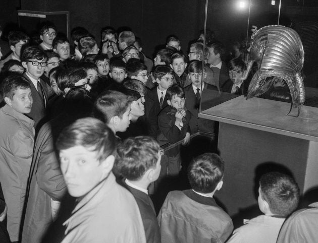 Groupe de jeunes devant le masque funéraire du pharaon Toutankhamon lors de l'exposition «Toutankhamon et son temps» au musée du Petit Palais à Paris en France, le 23 mars 1967.