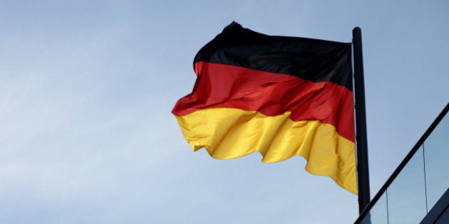 BERLIN - JUNE 30: A German flag waves in the wind over the Bundestag and the Reichstag building during the election of a new German president by the Federal Assembly on June 30, 2010 in Berlin, Germany. The Federal Assembly, which is comprised of Bundestag parliamentarians and other nationwide delegates, will choose a new president following the unexpected resignation of German President Horst Koehler at the end of May. The two main candidates are Christian Wulff, the official candidate of the ruling German government coalition, the Christian Democrats (CDU) and Free Democrats (FDP), and Joachim Gauck, who has the backing of the German Social Democrats (SPD) and the German Greens party. (Photo by Sean Gallup/Getty Images)