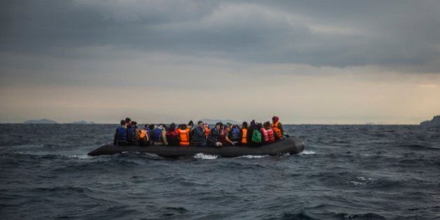 Refugees and migrants onboard a dinghy approach the Greek island of Lesbos, after crossing the Aegean sea from Turkey, Saturday, Jan. 2, 2016. More than a million people reached Europe in 2015 in the continent's largest refugee influx since the end of World War II. Nearly 3,800 people are estimated to have drowned in the Mediterranean last year, making the journey to Greece or Italy in unseaworthy vessels packed far beyond capacity. (AP Photo/Santi Palacios)