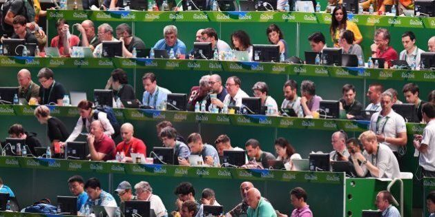 Journalists work ahead of the opening ceremony of the Rio 2016 Olympic Games at the Maracana stadium in Rio de Janeiro on August 5, 2016. / AFP / GABRIEL BOUYS (Photo credit should read GABRIEL BOUYS/AFP/Getty Images)