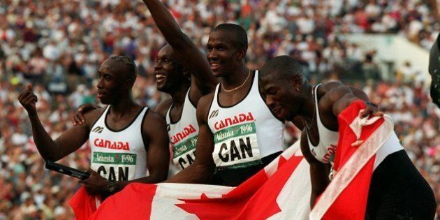 The Canadian men's 4X100 meter relay team celebrate after winning the gold medal at the Summer Olympic Games in Atlanta, Saturday, August 3, 1996. Seen from left to right are Robert Esmie, Bruny Surin, Donovan Bailey and Glenroy Gilbert. (AP Photo/Denis Paquin)