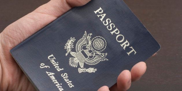 Close up of man's hand holding passport