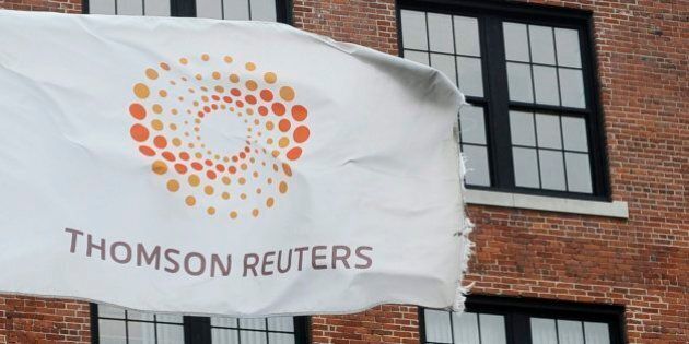 FILE-- A flag displaying the Thomson Reuters logo flies outside a company building, Monday, Aug. 11, 2008 in Boston. Reuters says it had a 30 per cent lower profit and slightly higher revenue in the first quarter compared with the same period last year. (AP Photo/Lisa Poole)