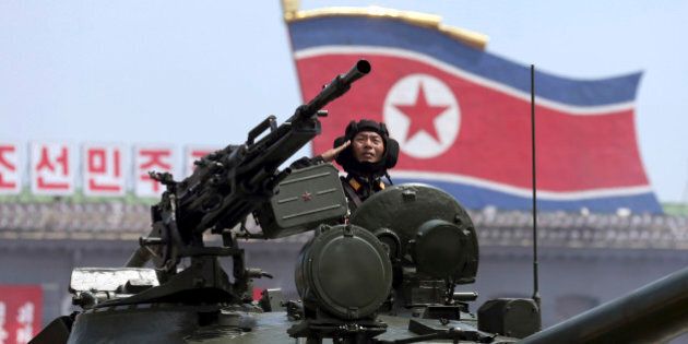 In this Saturday, July, 27, 2013, file photo, a North Korean soldier salutes while in a military tank as they parade through Kim Il Sung Sqaure during a mass military parade celebrating the 60th anniversary of the Korean War armistice in Pyongyang, North Korea. Ever-wary of threats to its ruling regime and still technically at war with Washington and Seoul, âMilitary Firstâ is North Koreaâs national motto. (AP Photo/Wong Maye-E, File)