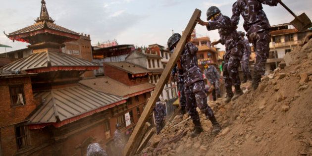 Nepalese policemen clear the debris at Basantapur Durbar Square, damaged in Saturdayâs earthquake, in Kathmandu, Nepal, Sunday, April 26, 2015. The earthquake centered outside Kathmandu, the capital, was the worst to hit the South Asian nation in over 80 years. It destroyed swaths of the oldest neighborhoods of Kathmandu, and was strong enough to be felt all across parts of India, Bangladesh, China's region of Tibet and Pakistan.(AP Photo/Bernat Armangue)