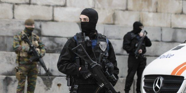 Belgian police officers and soldiers stand guard outside the Brussels Palace of Justice during the appearance before the council chamber of two individuals arrested in connection with the November 13 attacks in Paris, in Brussels on November 20, 2015. Mohammed Amri and Hamza Attou were arrested in Belgium and charged with 'a terrorist act and participation in the activities of a terrorist group.' AFP PHOTO / BELGA / NICOLAS LAMBERT --BELGIUM OUT-- (Photo credit should read NICOLAS LAMBERT/AFP/Getty Images)