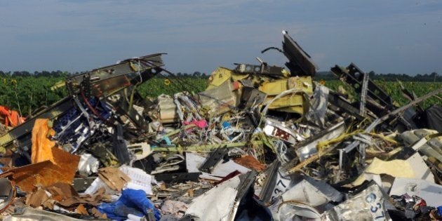 A single shoe is seen on July 19, 2014 at the wreckage of Malaysia Airlines flight MH17 two days after it crashed in a sunflower field near the village of Rassipnoe, in rebel-held eastern Ukraine. Ukraine and pro-Russian insurgents agreed on July 19 to set up a security zone around the crash site of a Malaysian jet whose downing in the rebel-held east has drawn global condemnation of the Kremlin. Outraged world leaders have demanded Russia's immediate cooperation in a prompt and independent probe into the shooting down on July 17 of flight MH17 with 298 people on board. AFP PHOTO / DOMINIQUE FAGET (Photo credit should read DOMINIQUE FAGET/AFP/Getty Images)