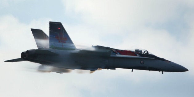 TORONTO, ON- SEPTEMBER 1 - The CF-18 Hornet generates vapour as it climbs races by the grandstand at the Canadian International Air Show that closes out the final weekend of the Canadian National Exhibition at CNE Grounds in Toronto, September 1, 2013. (Steve Russell/Toronto Star via Getty Images)