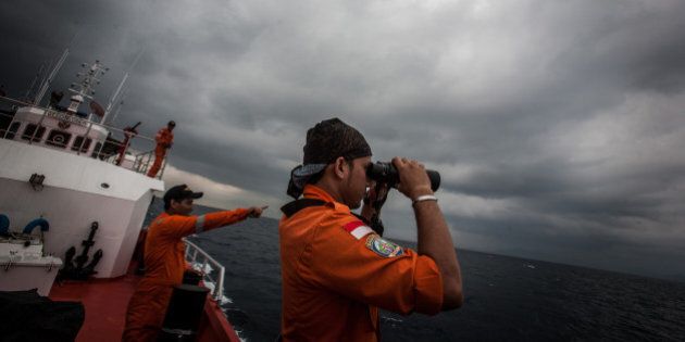 Indonesian national search and rescue agency personel watch over high seas during a search operation for missing Malaysia Airlines flight MH370 in the Andaman Sea on March 15, 2014. Investigators now believe a Malaysian jet that vanished was commandeered by a 'skilled, competent' flyer who piloted the plane for hours, a senior Malaysian military official said on March 15 as Prime Minister Najib Razak prepared to address the nation. AFP PHOTO/ Chaideer MAHYUDDIN (Photo credit should read CHAIDEER MAHYUDDIN/AFP/Getty Images)
