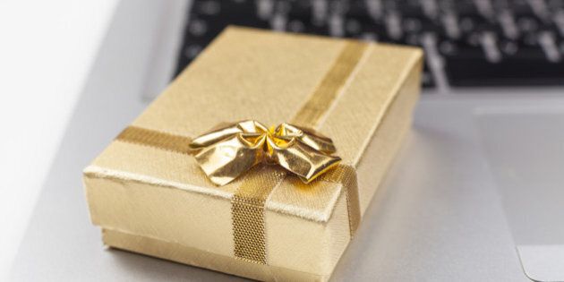 gold gift box on silver laptop...