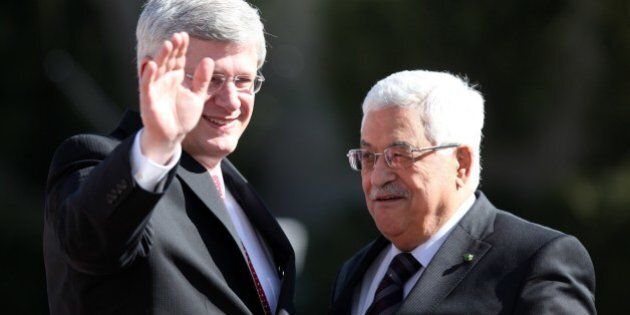 Canadian Prime Minister Stephen Harper (L) waves as he is welcomed by Palestinian President Mahmoud Abbas (R) upon his arrival for bilateral talks in the West Bank city of Ramallah on January 20, 2014. Canada is one of Israel's staunchest allies and was one of the few countries that opposed a successful Palestinian bid for upgraded status at the United Nations in 2012. AFP PHOTO ABBAS MOMANI (Photo credit should read ABBAS MOMANI/AFP/Getty Images)