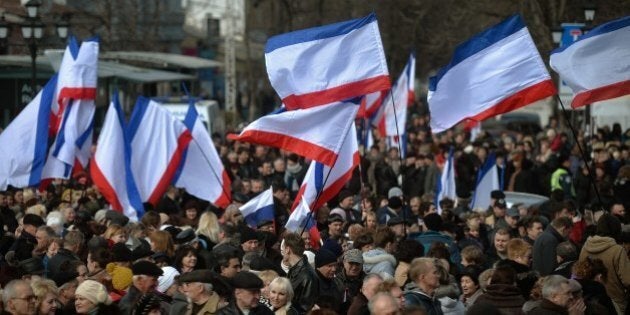 People gather at a pro Russian rally in Simferopol's Lenin Square on March 9, 2014. Ukrainian Prime Minister Arseniy Yatsenyuk on Sunday vowed Ukraine would not give 'an inch' of its territory to Russia, at a rally of thousands of people in Kiev in honour of 19th-century national hero Taras Shevchenko. AFP PHOTO/Filippo MONTEFORTE (Photo credit should read FILIPPO MONTEFORTE/AFP/Getty Images)