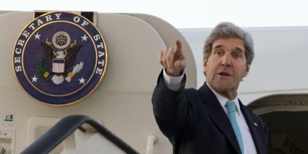 US Secretary of State John Kerry points as he says goodbye while boarding his plane at dawn to leave Amman on March 27, 2014, en route to Rome, where he will join US President Barack Obama for a meeting with Pope Francis. Kerry flew to the Jordanian capital for talks with Palestinian president Mahmud Abbas on the Middle East peace process. AFP PHOTO/JACQUELYN MARTIN/POOL (Photo credit should read JACQUELYN MARTIN/AFP/Getty Images)