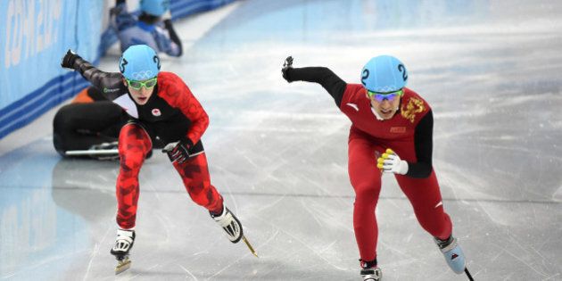 China's Wu Dajing (R) and Canada's Charle Cournoyer compete in the Men's Short Track 500 m Quarterfinals at the Iceberg Skating Palace during the Sochi Winter Olympics on February 21, 2014. AFP PHOTO / DAMIEN MEYER (Photo credit should read DAMIEN MEYER/AFP/Getty Images)