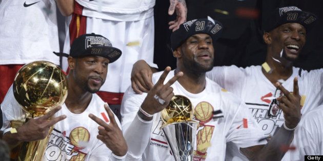 Dwyane Wade (L), LeBron James (C) and Chris Bosh (R) of the Miami Heat celebrate winning Game 7 of the NBA Finals at the American Airlines Arena June 20, 2013 in Miami, Florida. The Miami Heat, led by NBA Most Valuable Player LeBron James, won the NBA Finals for the second consecutive year by defeating the San Antonio Spurs 95-88 in game seven of the championship series. AFP PHOTO / Brendan SMIALOWSKI (Photo credit should read BRENDAN SMIALOWSKI/AFP/Getty Images)