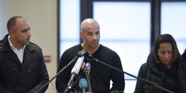 Malek Merabet (C), the brother of Ahmed Merabet, the policeman who was killed in the attacks at the offices of the Charlie Hebdo magazine on January 7, talks during a press conference in Livry-Gargan, northern Paris suburb, on January 10, 2015 with Ahmed's brother-in-law Lotfi Mabrouk (L), and Ahmed's partner Morgane. French forces were on January 10 frantically hunting for Islamist gunman Amedy Coulibaly's 26-year-old girlfriend, Hayat Boumeddiene, as the country mourned 17 dead in three blood-soaked days, hours after a dramatic end to twin sieges that also resulted in the death of two brothers who had killed 12 at the offices of the Charlie Hebdo magazine on January 7. More than 200,000 people took to streets in France on January 10 to show their solidarity after three days of bloody attacks which killed 17 victims at the hands of Islamic extremists, according to a tally of various demonstrations. AFP PHOTO / MARTIN BUREAU (Photo credit should read MARTIN BUREAU/AFP/Getty Images)