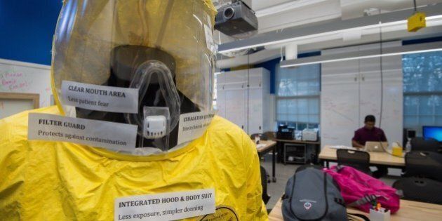 A new and improved prototype bio-hazard suit specifically targeted for viral outbreaks such as Ebola is seen at the Johns Hopkins Biomedical Engineering Laboratory for Innovation and Design on December 18, 2014. Made of Tyvek, the bright yellow outfit is easier than current Ebola protection suits to remove, lowering the risk of a health care worker contracting the deadly virus. It also features a ventilation system, making it possible to wear the suit for hours in West Africa's tropical heat without discomfort. AFP PHOTO/PAUL J. RICHARDS (Photo credit should read PAUL J. RICHARDS/AFP/Getty Images)