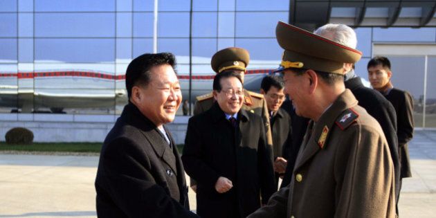 North Korean leader Kim Jong Un's special envoy Choe Ryong Hae, left, a senior member of the Presidium of the Political Bureau and secretary of the Central Committee of the Workers' Party, shakes hands with Hwang Pyong So, director of the General Political Bureau of the Korean People's Army, as he and his delegation members leave the Pyongyang Airport in Pyongyang, North Korea, for Russia Monday, Nov. 17, 2014. Choe, one of Kim's close associates, left Pyongyang on Monday to discuss ways to improve trade and political ties with Russia. He is scheduled to stay in Russia until Nov. 24. Delegation member Kim Kye Gwan, first vice-minister of Foreign Affairs, is seen second left. (AP Photo/Jon Chol Jin)