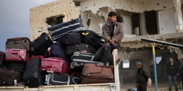 Palestinians await permission to enter Egypt as they gather inside the Rafah border crossing between Egypt and southern Gaza Strip on December 21, 2014. Egypt is set to reopen the Rafah border crossing with Gaza for the second time in two months to allow those stranded in Egypt to enter the Palestinian territory, officials said. AFP PHOTO / SAID KHATIB (Photo credit should read SAID KHATIB/AFP/Getty Images)