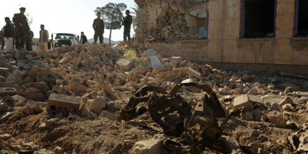 Afghan National Army (ANA) soldiers stand at the site of a Taliban attack in Farah province on April 4, 2013. Taliban gunmen who killed 46 people at an Afghan court complex in a bid to free insurgents standing trial moved ruthlessly from room to room, shooting everyone they found, officials recounted on April 3. Defenceless civilians, judges, lawyers and court staff were left dead after nine militants disguised as Afghan soldiers launched an eight-hour assault which only ended after security forces finally killed the last surviving gunman. AFP PHOTO/ Aref Karimi (Photo credit should read Aref Karimi/AFP/Getty Images)