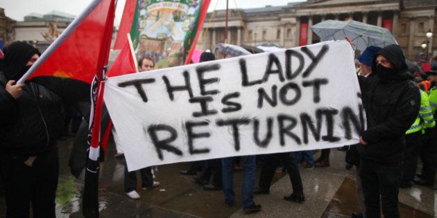 LONDON, ENGLAND - APRIL 13: Protesters hold a sign saying 'The Lady Is Not Returning' during a party held in Trafalgar Square following the death of the former British Prime Minister Margaret Thatcher on April 13, 2013 in London, England. Downing Street announced that the funeral of former Prime Minister Baroness Thatcher will take place at London's St Paul's Cathedral on April 17. (Photo by Jordan Mansfield/Getty Images)