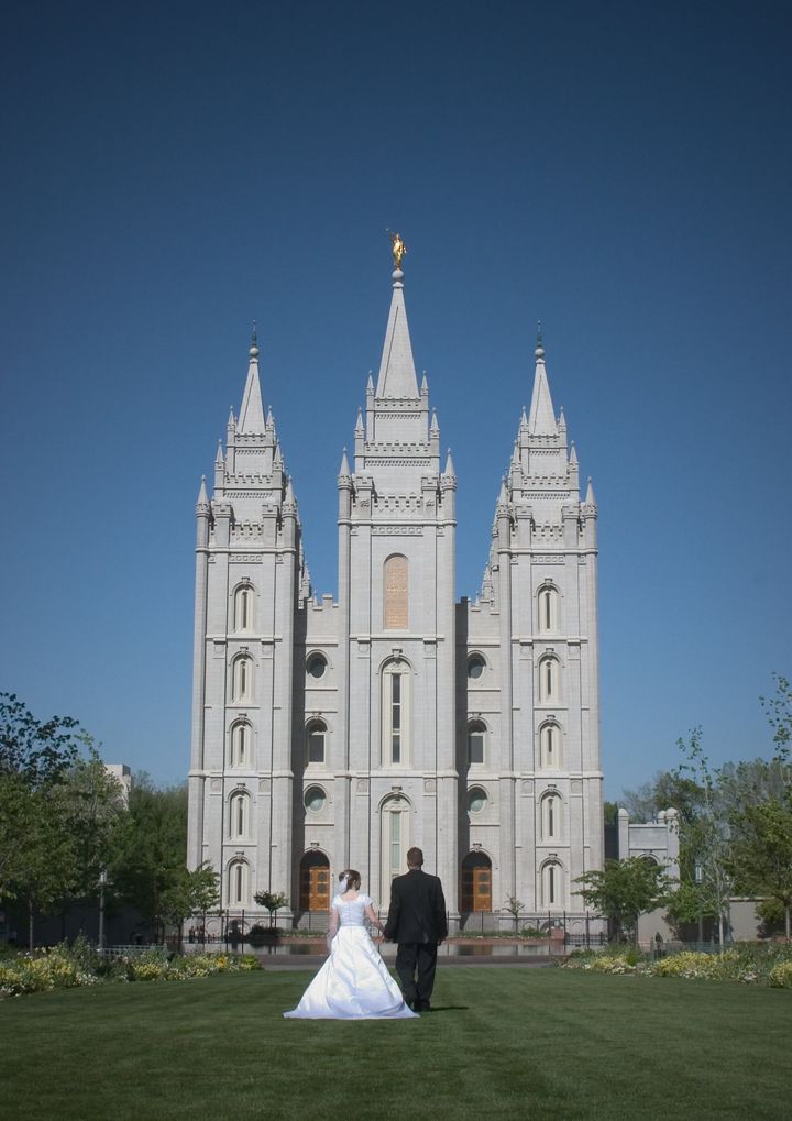 A couple poses outside the Salt Lake City temple in Utah.