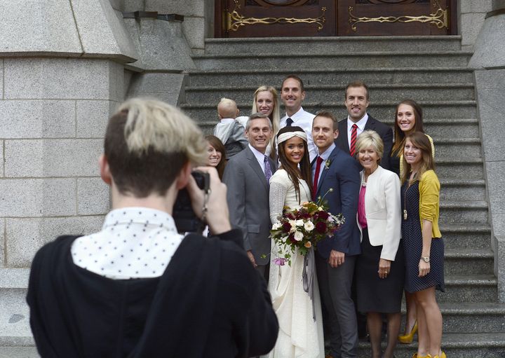 A couple poses for a photograph with members of their wedding party on Sept. 27, 2014, after their wedding ceremony inside the Salt Lake Temple in Salt Lake City.