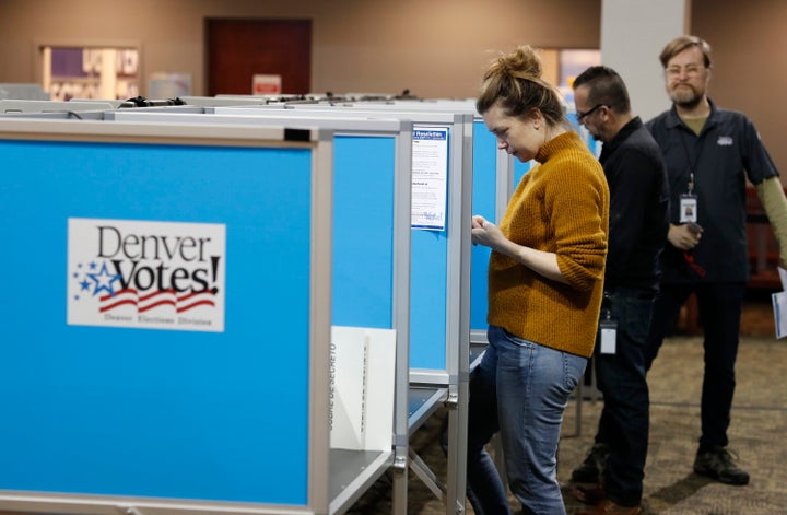 Voters fill out their ballots at the Denver Elections Division Tuesday, May 7, 2019, in Denver.