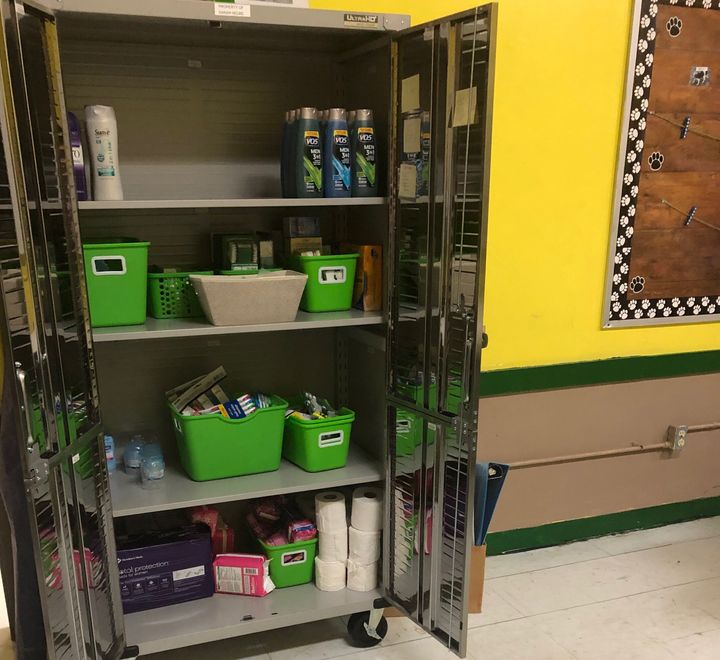 The shiny metal cabinet in Sarah Helms' sixth grade classroom is full of necessary supplies — not paper and pencils, but personal care products.