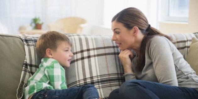 Mother and son (6-7) sitting on sofa