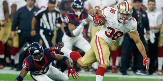 HOUSTON, TX - AUGUST 15: Jarryd Hayne #38 of the San Francisco 49ers breaks the tackle attempt of Rahim Moore #26 of the Houston Texans in the first half at Reliant Arena at Reliant Park on August 15, 2015 in Houston, Texas. (Photo by Bob Levey/Getty Images)