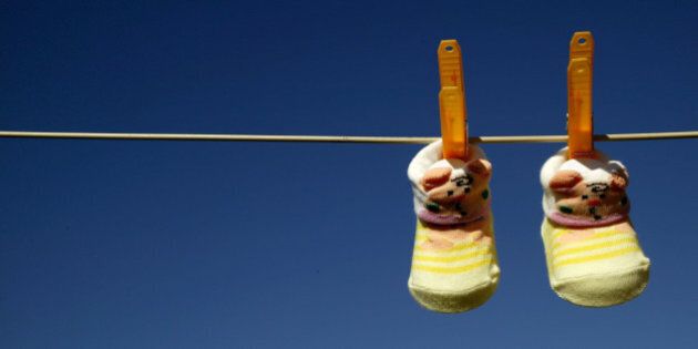 (AUSTRALIA & NEW ZEALAND OUT) A pair of baby booties hang on the clothesline, 21 September 2004. AFR Picture by VIRGINIA STAR (Photo by Fairfax Media via Getty Images)