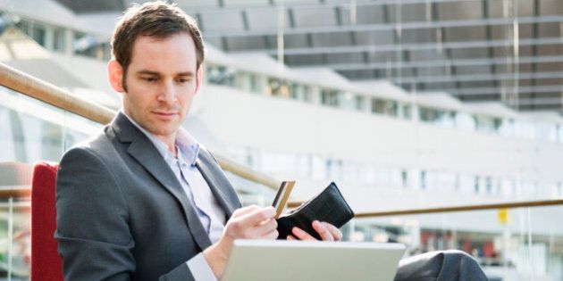 Businessman with laptop and wallet