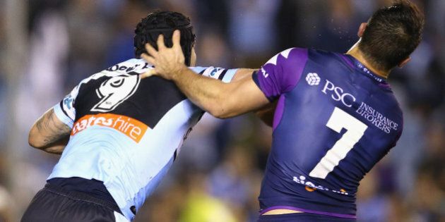 SYDNEY, AUSTRALIA - AUGUST 17: Michael Ennis of the Sharks pushes away Cooper Cronk of the Storm as they scuffle during the round 23 NRL match between the Cronulla Sharks and the Melbourne Storm at Remondis Stadium on August 17, 2015 in Sydney, Australia. (Photo by Mark Kolbe/Getty Images)