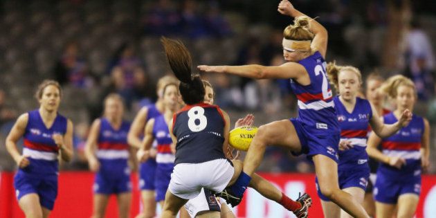 MELBOURNE, AUSTRALIA - AUGUST 16: Kellie Gibson (R) of the Bulldogs collides with and tumbles over Britany Bonnici of the Demons during a Women's AFL exhibition match between Western Bulldogs and Melbourne at Etihad Stadium on August 16, 2015 in Melbourne, Australia. (Photo by Michael Dodge/Getty Images)