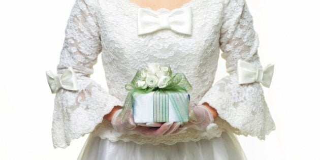 Photography of a bride holding a present in hands, Front View