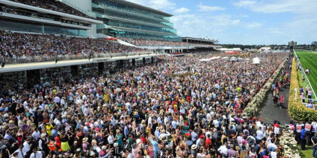 MELBOURNE, AUSTRALIA - NOVEMBER 04: General view of crowds as the field makes its way to the start of Race 7, the Emirates Melbourne Cup on Melbourne Cup Day at Flemington Racecourse on November 4, 2014 in Melbourne, Australia. (Photo by Vince Caligiuri/Getty Images)