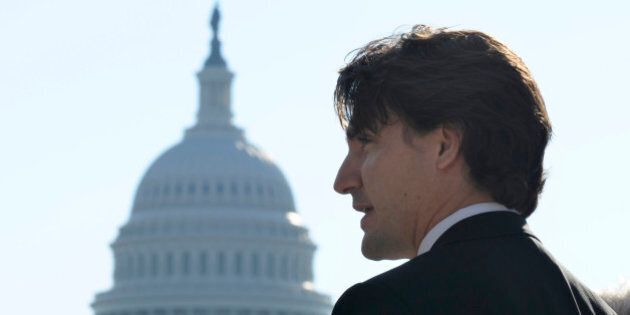 With the Capitol dome in the background, Canadian Liberal Leader Justin Trudeau speaks to reporters during his first official visit to Washington since becoming Liberal Leader, Friday, Oct. 25, 2013, in Washington. (AP Photo/Susan Walsh)