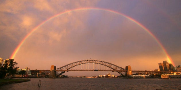 A rainbow forms over the Harbour Bridge on a wet day in Sydney Wednesday, June 17, 2015. (AP Photo/Rick Rycroft)