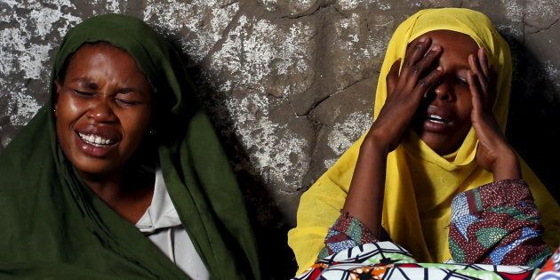 Two women weep and pray for their relative Ndayizeye Janvier Abdul, 36, who was killed by the Imbonerakure, the feared youth wing of the governing party in Burundi.