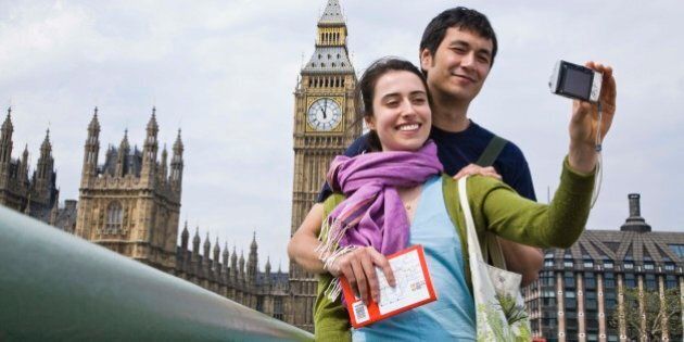 Couple posing for self portrait by Big Ben, London, England