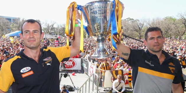 MELBOURNE, AUSTRALIA - OCTOBER 02: Shannon Hurn the captain of the Eagles and Luke Hodge the captain of the hawks pose with the Premiership trophy during the 2015 AFL Grand Final parade on October 2, 2015 in Melbourne, Australia. (Photo by Quinn Rooney/Getty Images)