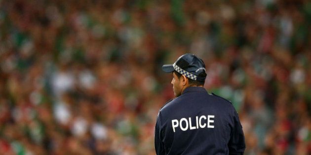 SYDNEY, AUSTRALIA - OCTOBER 05: A policeman looks on during the 2014 NRL Grand Final match between the South Sydney Rabbitohs and the Canterbury Bulldogs at ANZ Stadium on October 5, 2014 in Sydney, Australia. (Photo by Mark Kolbe/Getty Images)