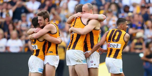 MELBOURNE, AUSTRALIA - OCTOBER 03: The Hawks celebrate winning the 2015 AFL Grand Final match between the Hawthorn Hawks and the West Coast Eagles at Melbourne Cricket Ground on October 3, 2015 in Melbourne, Australia. (Photo by Quinn Rooney/Getty Images)